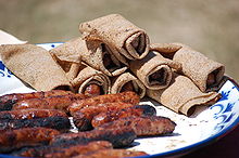 Photographie montrant des saucisses et des galettes-saucisses alignées sur une table.