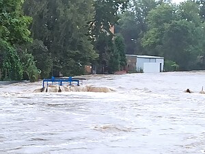 Elevated river levels in Prudnik, Poland flooding a bridge and nearby buildings on the river banks