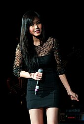 Rachelle Ann Go holding hand-held microphone