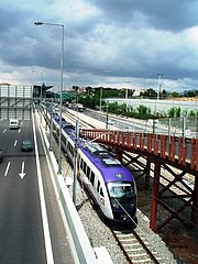 The A6 motorway (Attiki Odos) in Athens has commuter trains running in its median.