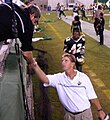 The Band Director shakes hand during a game